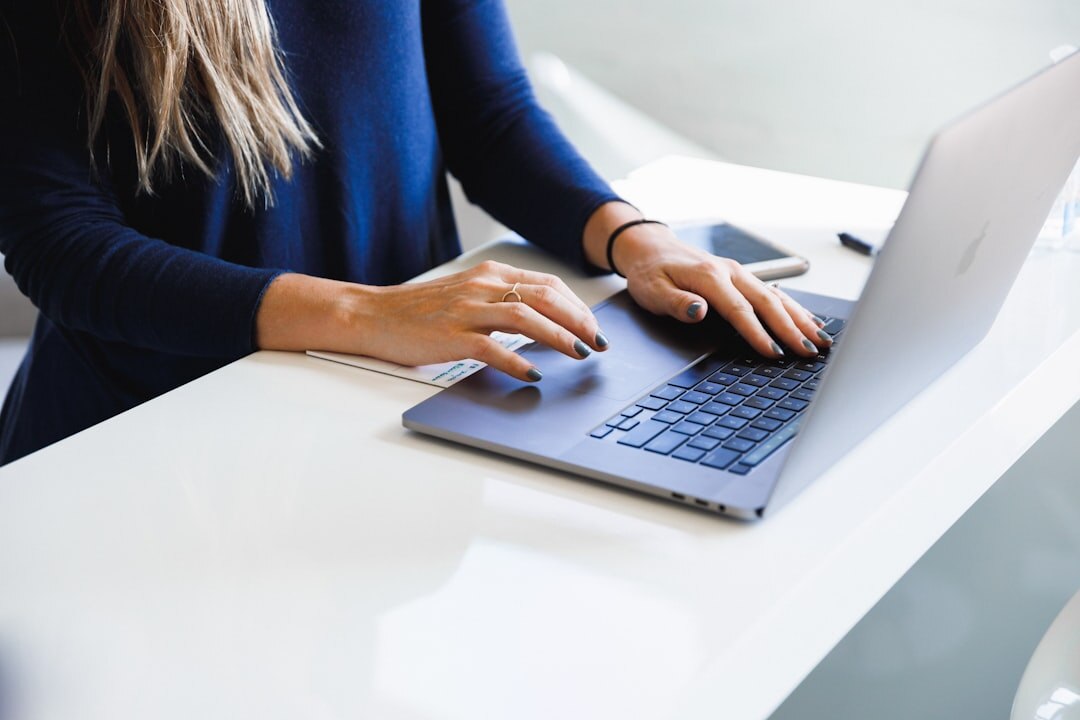 writer typing on laptop